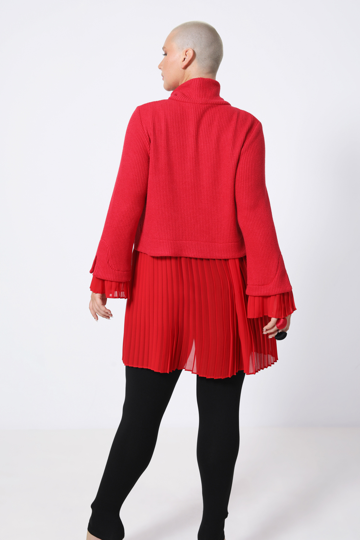 Plain sweater layered over pleated