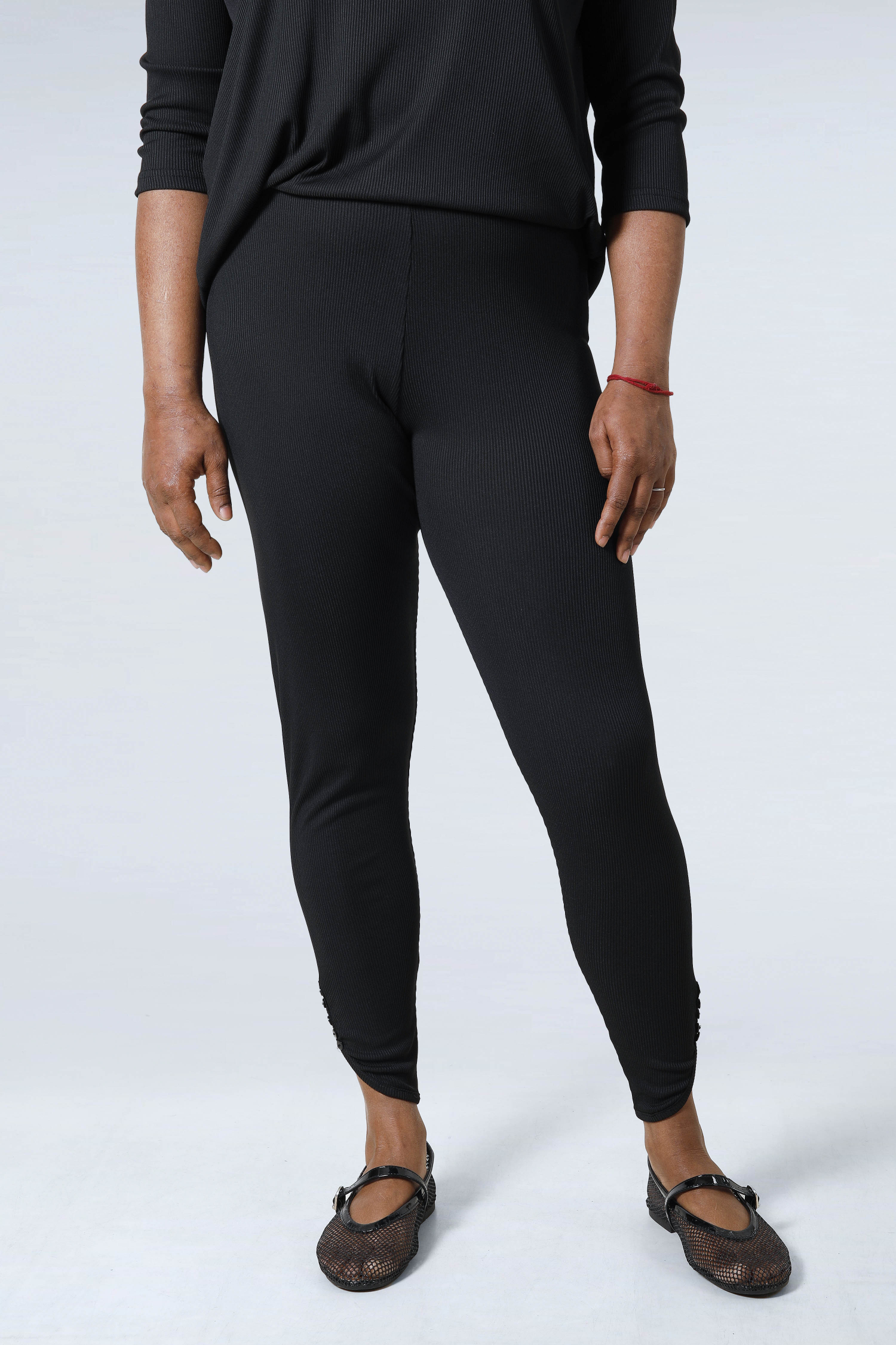 Plain knit leggings with row of buttons
