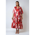 Long printed dress with a buttoned bib