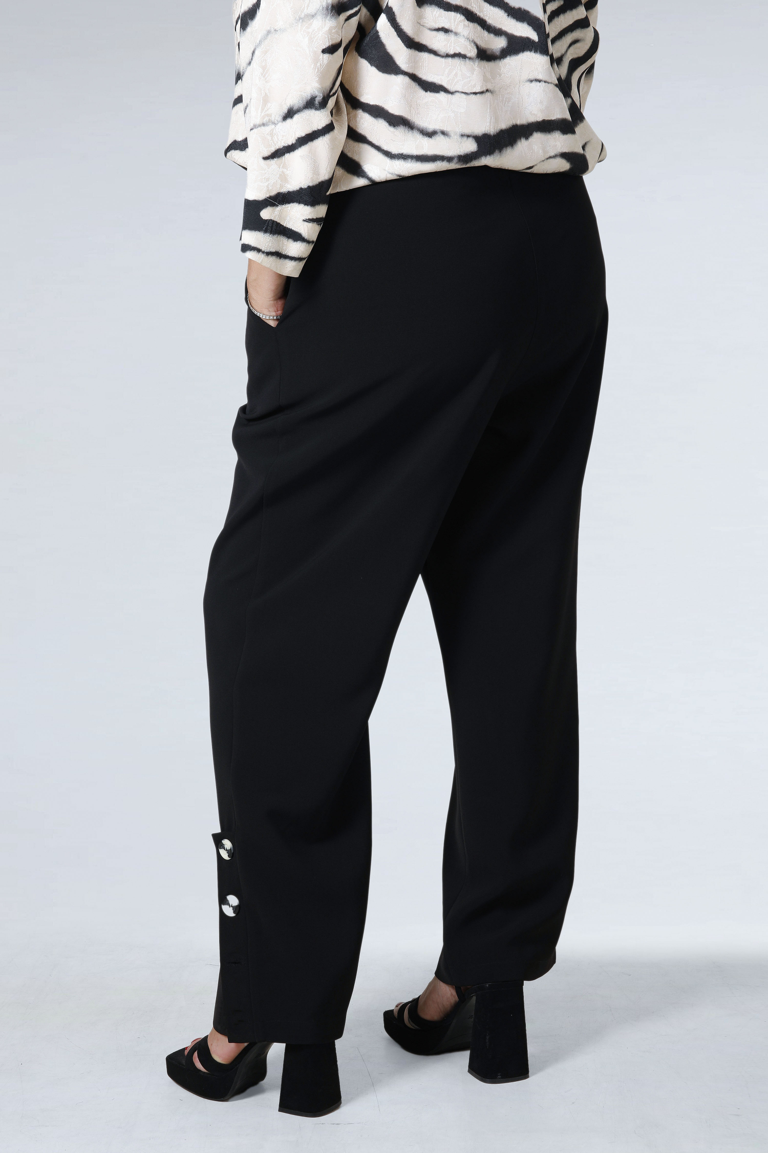 Plain tailored trousers with a decorative placket
